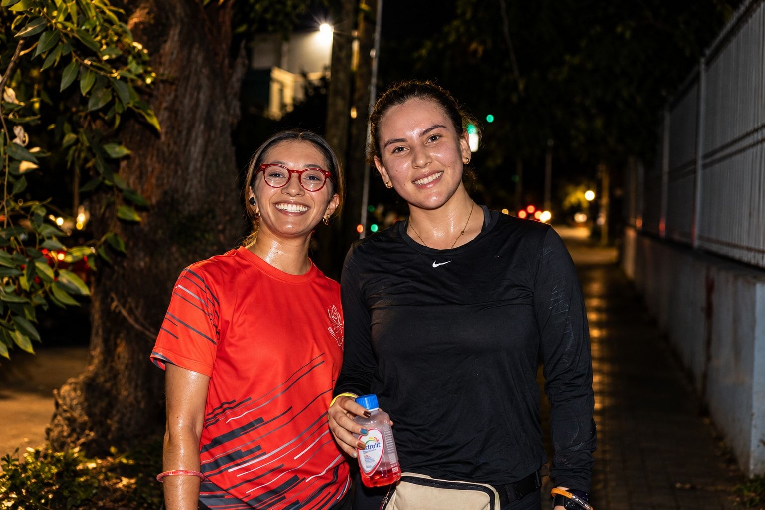 Two runners smiling at the camera after the run